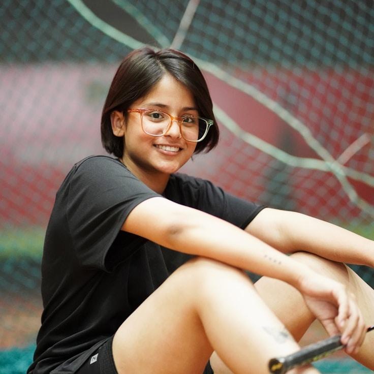 Kaveri Mehta, Lead Design Curator at LedgerGreenWave, reviewing corporate floral arrangements